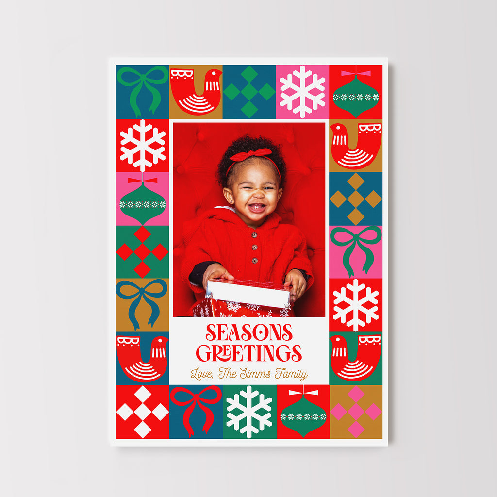 Colorful holiday card template in a vertical format with a single photo framed with geometric Christmas themed shapes. 