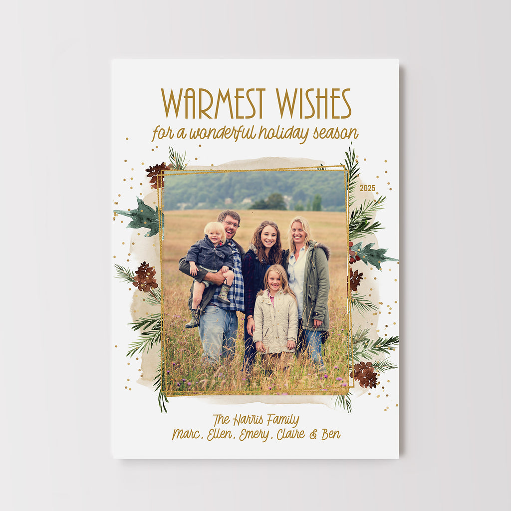 Christmas photo card with single photo framed by gold and evergreen graphics on a white background. 
