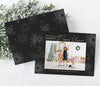 new year holiday photo card in landscape format with a single photo, black background, gold text and white firework graphics
