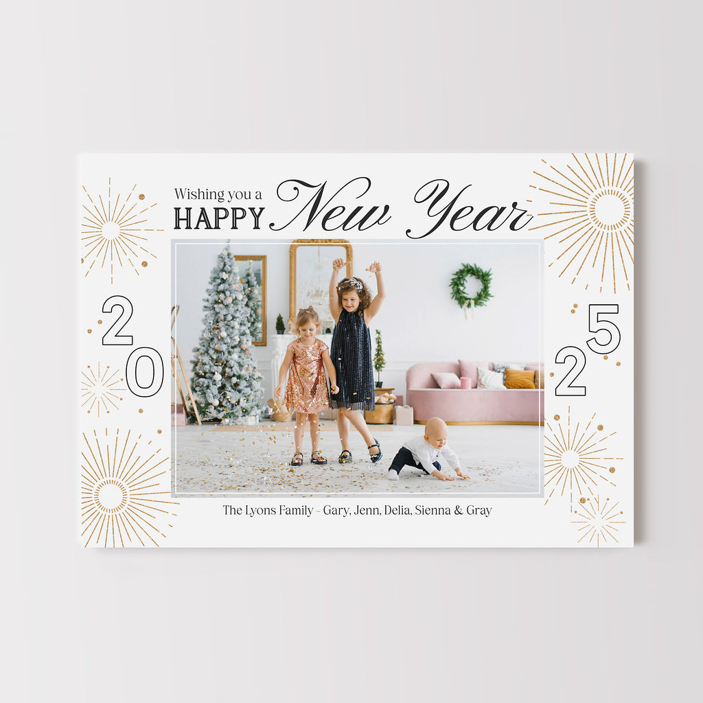 New year photo card with a single photo on a white background framed with gold fireworks and black text. 