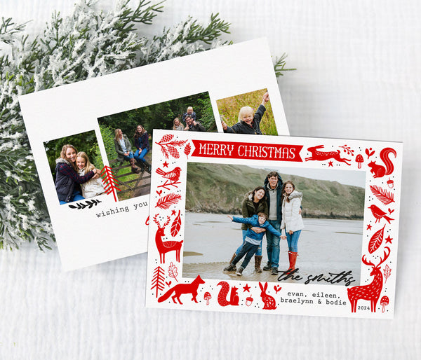 landscape oriented christmas card with a single photo on a white background framed by red folk style woodland animal graphics