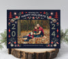 christmas photo card with a dark navy background, a single photo framed with red and green nordic themed holiday graphics
