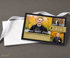 senior celebration graduation announcement in horizontal format with a black background with gray stripes, gold accent color and 3 photos, printed with stack of white envelopes