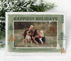 landscape oriented holiday card with a single photo framed by green and copper shapes against a green and white watercolor 