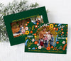 horizontal christmas or holiday card with a single circular photo framed with vintage floral graphics against a green background