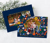 horizontal christmas or holiday card with a single circular photo framed with vintage floral graphics against a navy blue background