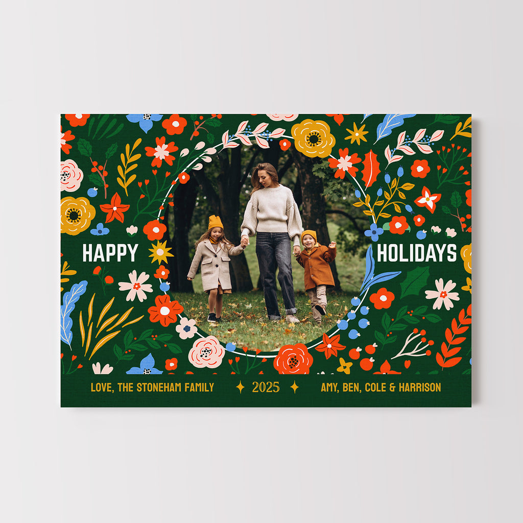 Holiday card with decorative border and circular family photo, featuring colorful flowers and leaves.
